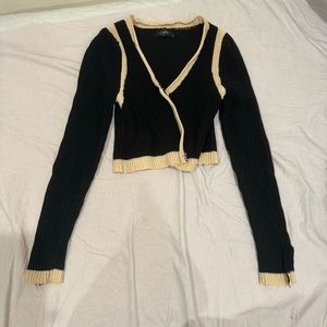 cream lined black ribbed sweater with button detailing